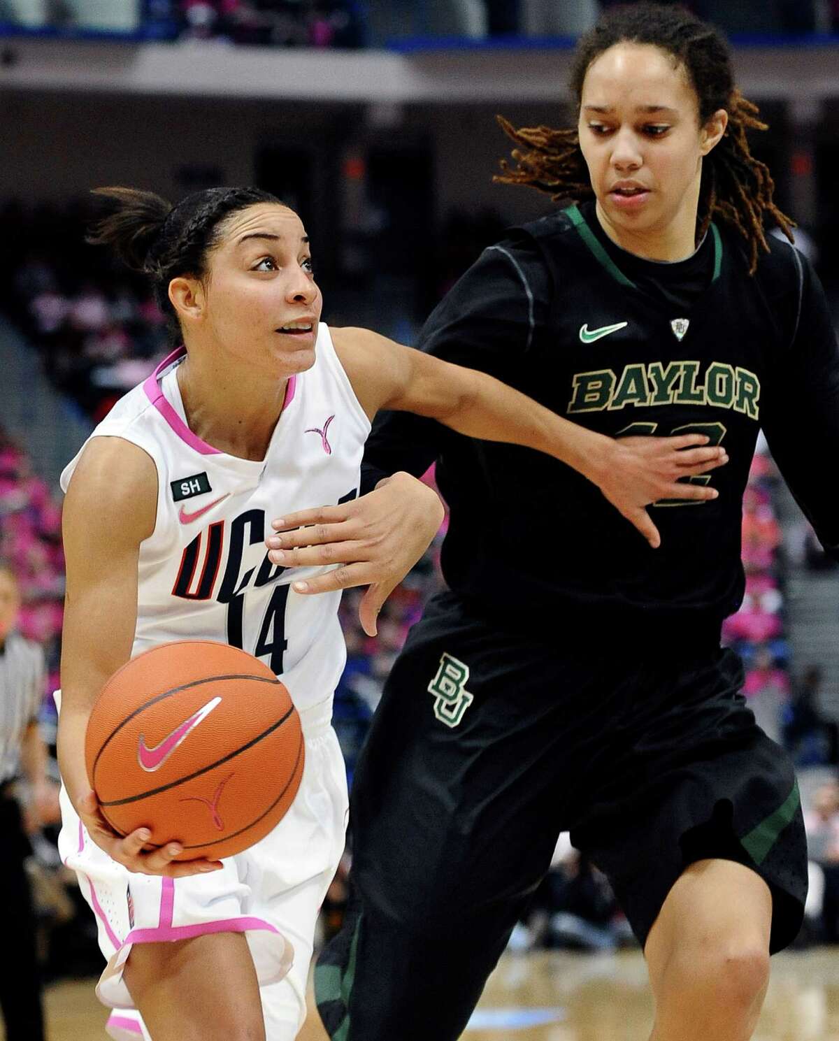 Connecticut's Bria Hartley, left, drives to the basket against Baylor's Brittney Griner during the first half of an NCAA college basketball game in Hartford, Conn., Monday, Feb. 18, 2013. (AP Photo/Jessica Hill)
