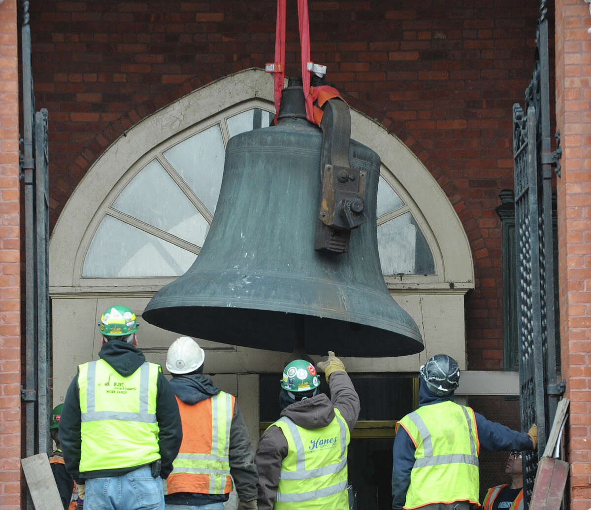 A large bell is lowered by a crane as workers removed the bell from the tower of the former St. Patrick's Church building on Tuesday, Feb. 19, 2013, in Watervliet, NY. (Paul Buckowski / Times Union)
