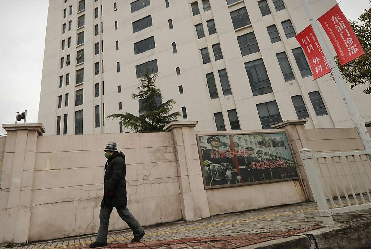 A person walks past a 12-storey building alleged in a report on February 19, 2013 by the Internet security firm Mandiant as the home of a Chinese military-led hacking group after the firm reportedly traced a host of cyberattacks to the building in Shanghai's northern suburb of Gaoqiao. Mandiant said its hundreds of investigations showed that groups hacking into US newspapers, government agencies, and companies "are based primarily in China and that the Chinese government is aware of them." AFP PHOTO / Peter PARKSPETER PARKS/AFP/Getty Images