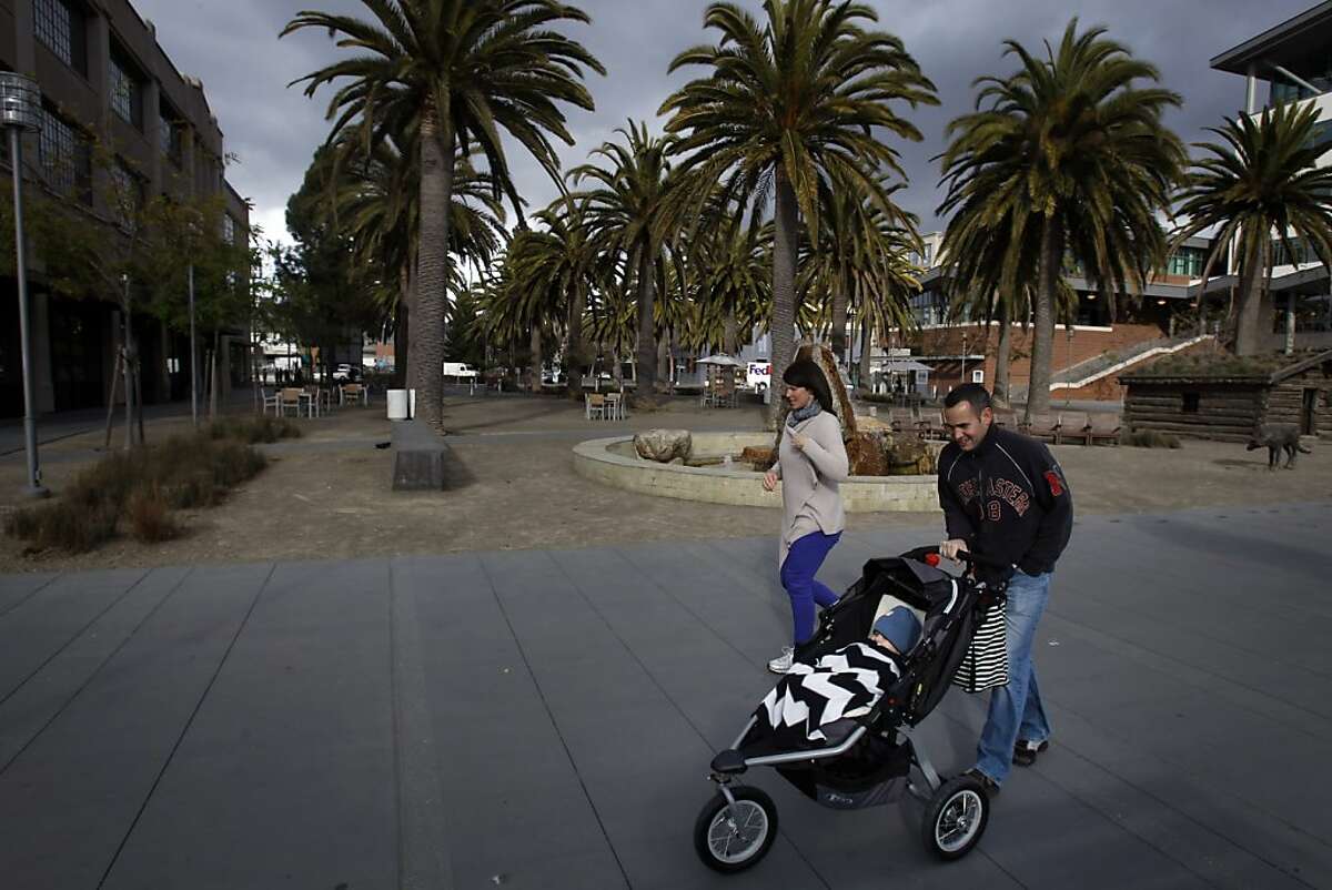 Pedestrians walk by Palm Plaza in Jack London Square at the end of Webster Street in Oakland, Calif., on Monday, February 18, 2013. The space holds several monuments to Jack London, including his cabin and Heinold's First And Last Chance Saloon, where London would spend time when he lived in Oakland.