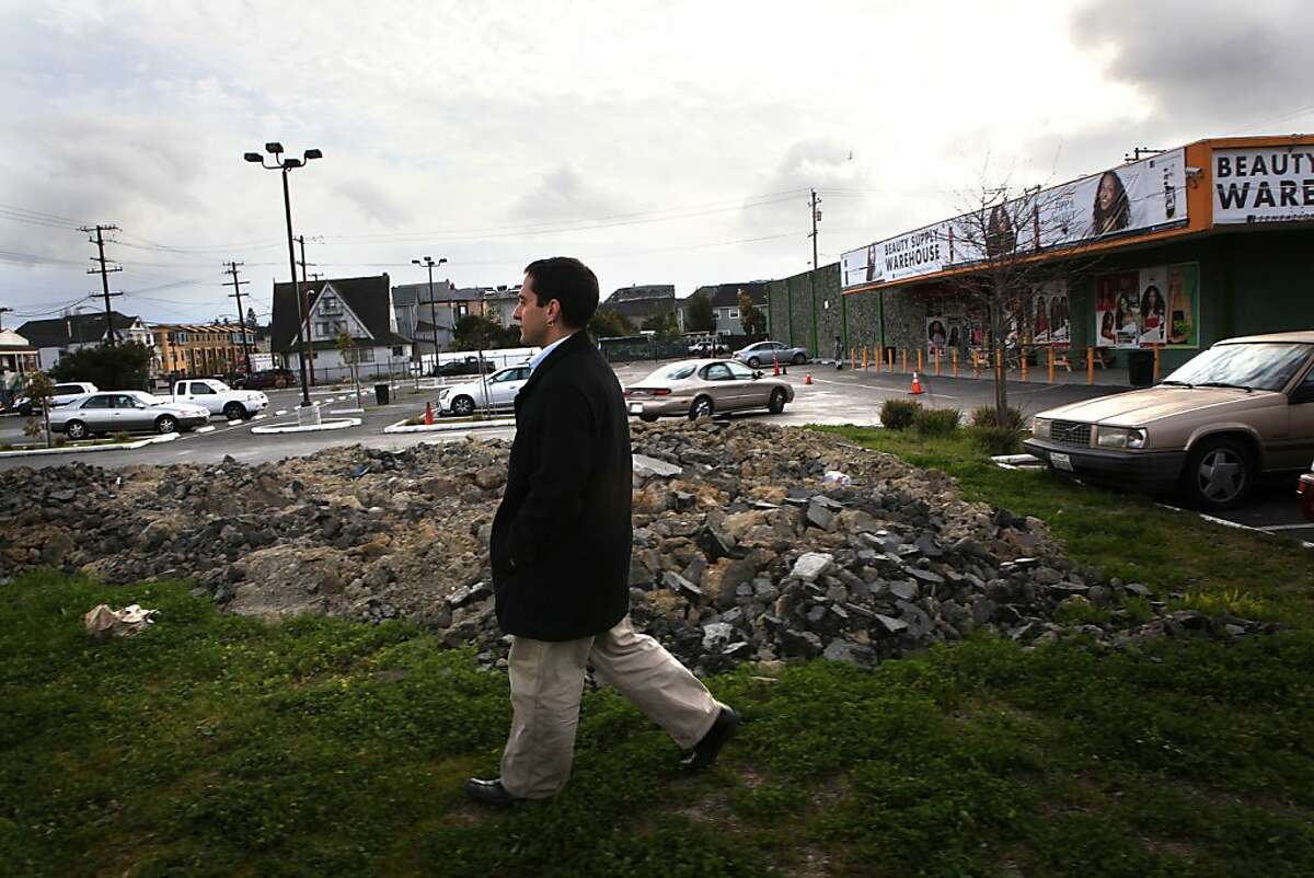 People's Grocery former director Brahm Ahmadi walks on a vacant lot at West Grand Shopping center in Oakland, Calif., where he plans to have his store site on Monday, February 18, 2013. He used to live a block away from the site and says the closest grocery store is 1.5 miles away.