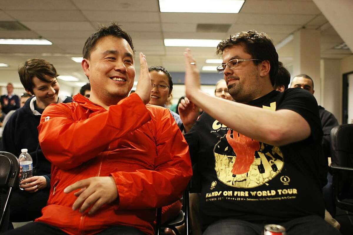 Members of Splendidly Dan Cheung, left, and Eric Goldberg exchange high fives after they were declared winners of the Startup Weekend on Sunday, Feb. 17. The Startup Weekend featured companies focused on the intersection of fashion and technology whose apps were looked at by judges.