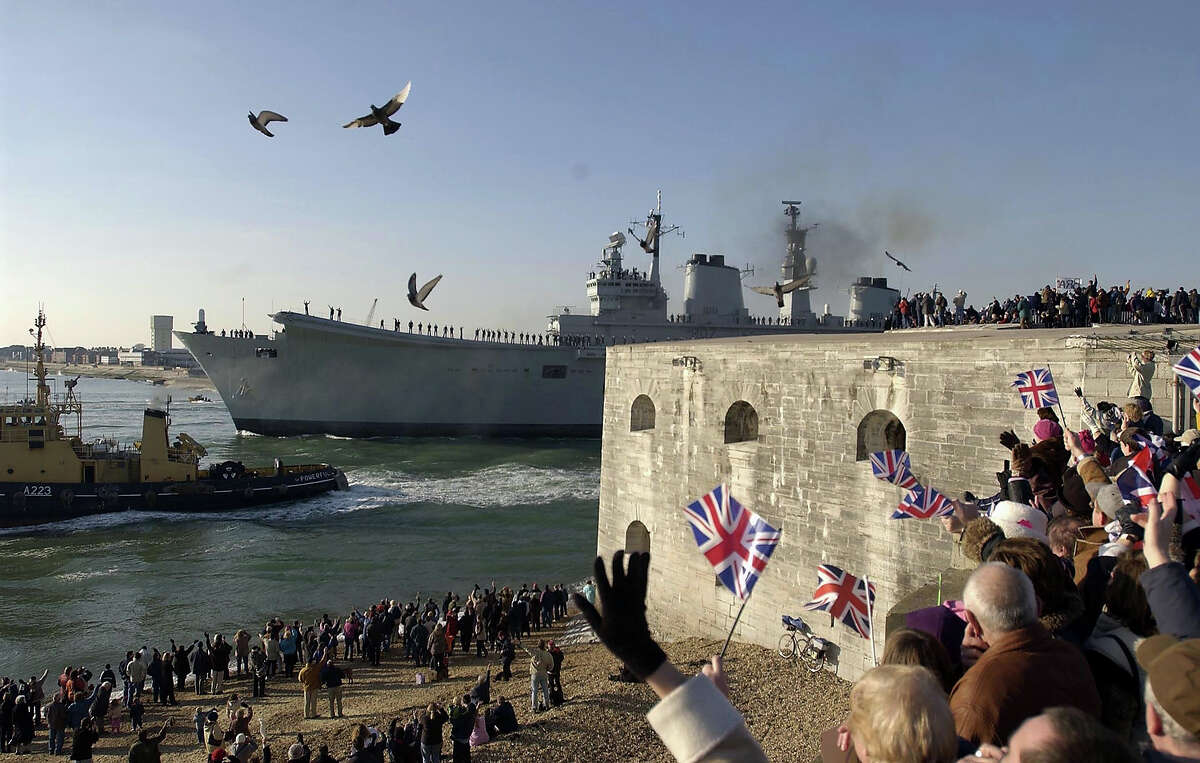 Members of the public line the shore as the aircraft carrier HMS Ark Royal leaves her base January 11 in Portsmouth, England, were she will lead a Naval Task Group to the Mediterranean. Ark Royal will fly the flag of the Commander UK Maritime Forces Rear Admiral David Snelson and it is widely beleived that the ship would take part in any military action against Iraq.
