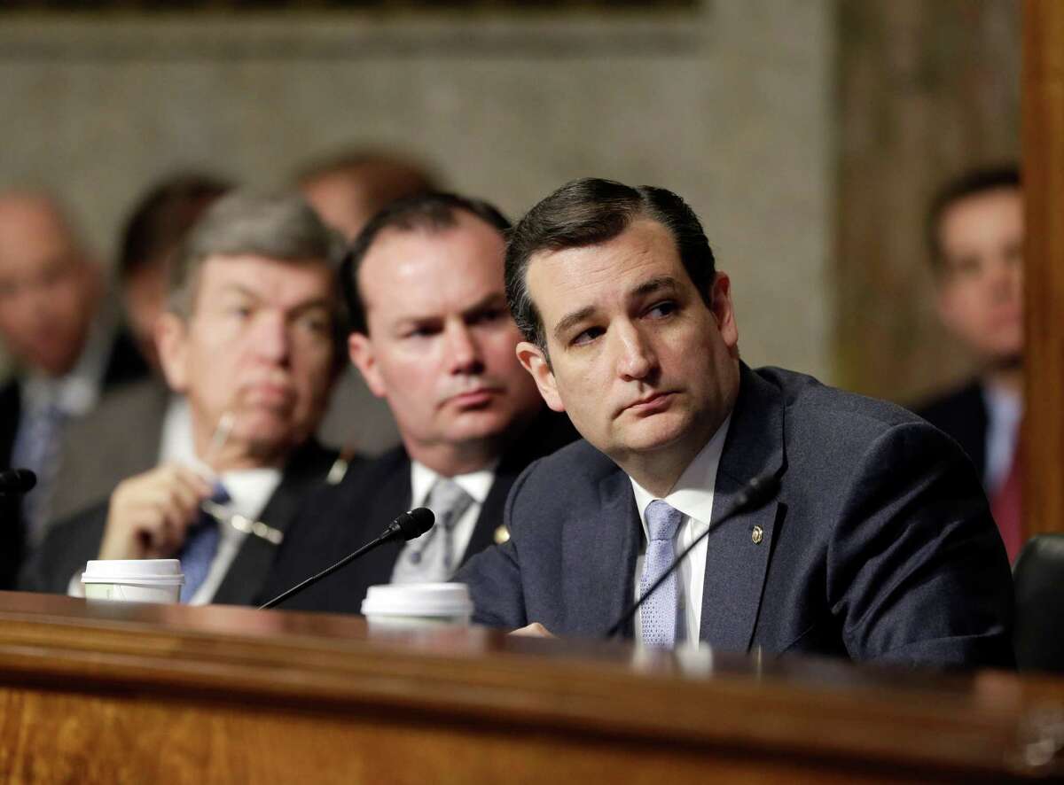 Sen. Ted Cruz (right) watches a video he provided with  GOP members of the Senate Armed Services Committee during his questioning of Chuck Hagel. Cruz is on a path that leads to the fringes of his party.