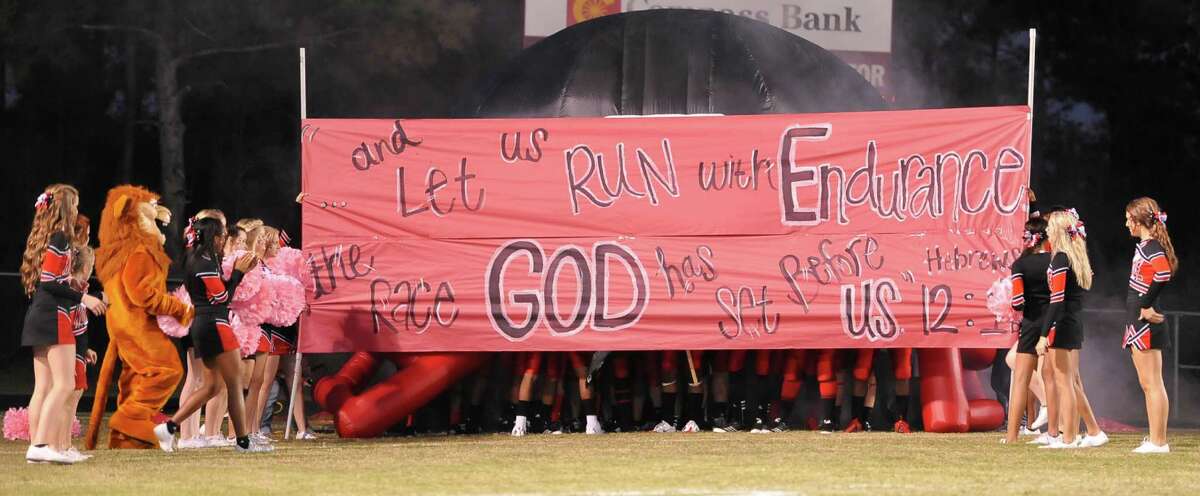The cheerleaders hold the break through sign for the team at the start of the game. This was the first home football game in Kountze since the sign controversy started and since the Thursday hearing that determined the cheerleaders could or could not use their faith-based signs. Dave Ryan/The Enterprise