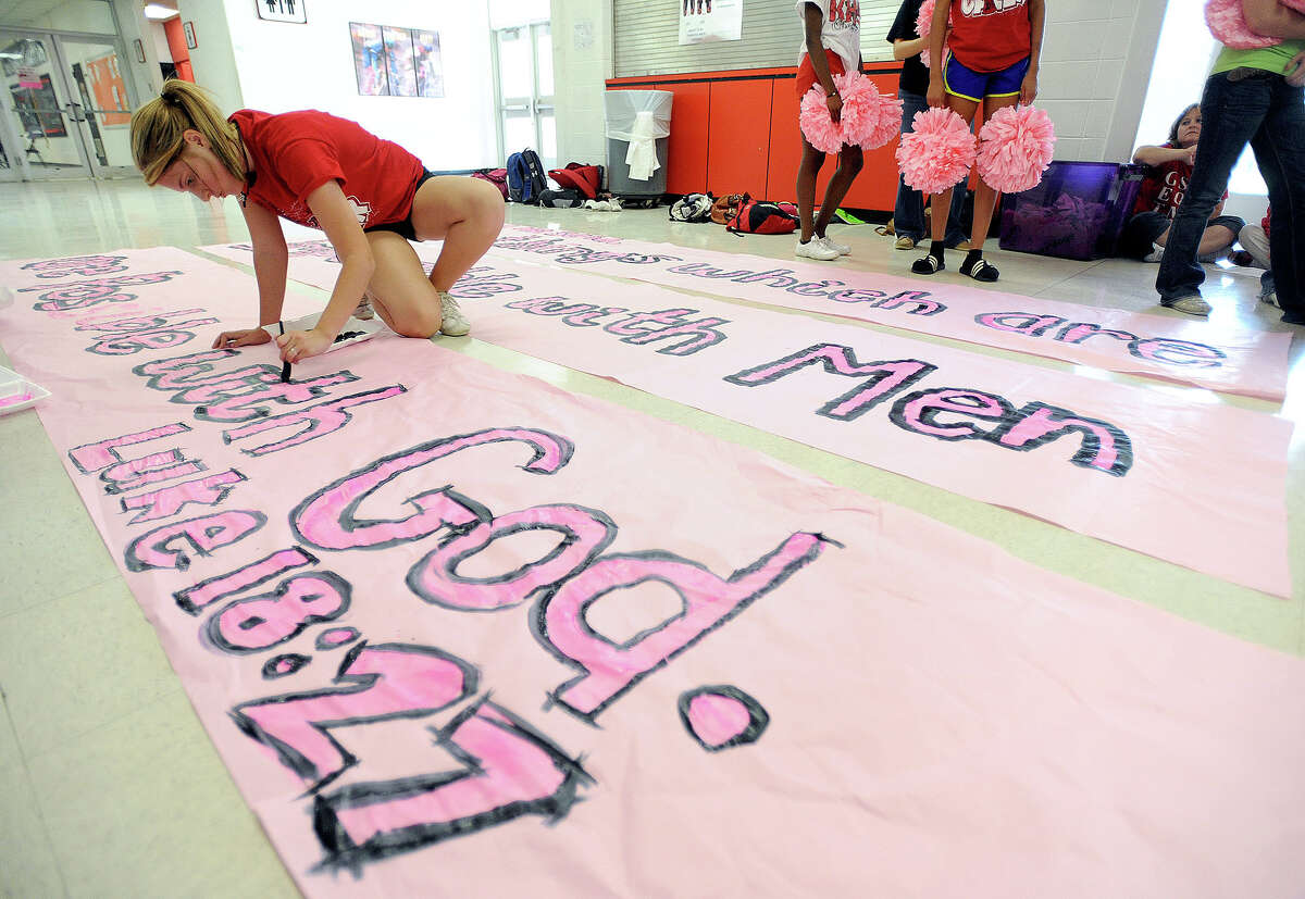 Texas Attorney General Greg Abbott said Tuesday that he supports the religious expression of the Kountze cheerleaders and the district's attorney's who claim the Texas Education Code is unconstitutional. Kountze cheerleader Cassie Page, 14, creates a banner Wednesday for Friday's football game. Photo taken Wednesday, October 17, 2012 Guiseppe Barranco/The Enterprise