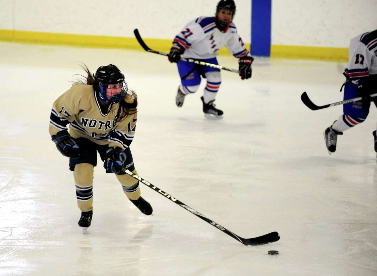 Notre Dame-Fairfield's Sebryna Buskey controls the puck during their ice hockey game against Fairfield Warde/Ludlowe co-op at Wonderland of Ice in Bridgeport, Conn. Wednesday, Feb. 20, 2013.