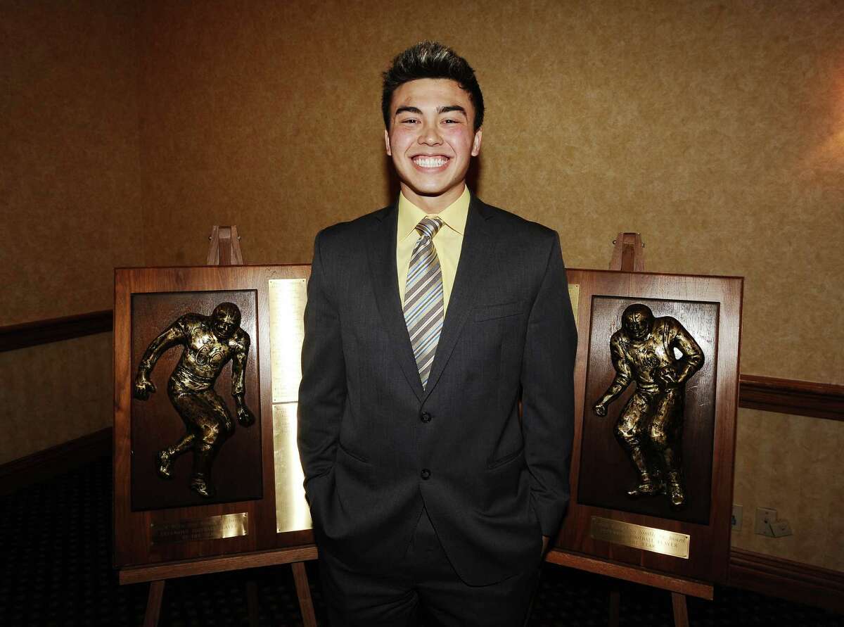 2012 offensive and defensive winner for the Coach Willie Ray Smith, Sr. Award, Montana Quirante, from Vidor High School stands next to the awards at the MCM Elegante' on Wednesday, February 20, 2013. Photo taken: Randy Edwards/The Enterprise