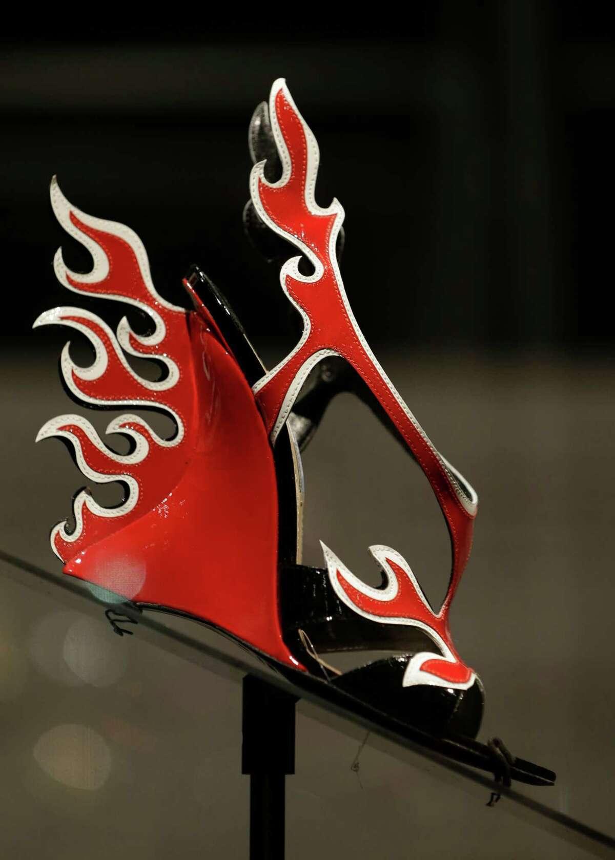 This Feb. 11, 2013 photo shows a red and white patent leather flame Prada sandal displayed at the "Shoe Obsession" exhibit at The Museum at the Fashion Institute of Technology Museum in New York. The exhibition, showing off 153 specimens, runs through April 13.