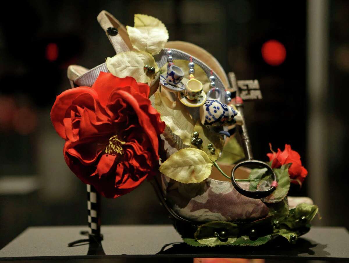 This Feb. 11, 2013 photo shows a shoe decorated with a miniature tea set and a lock titled "Alice," and designed by Nicholas Kirkwood, on display at the "Shoe Obsession" exhibit at The Museum at the Fashion Institute of Technology Museum in New York. The exhibition, showing off 153 specimens, runs through April 13.