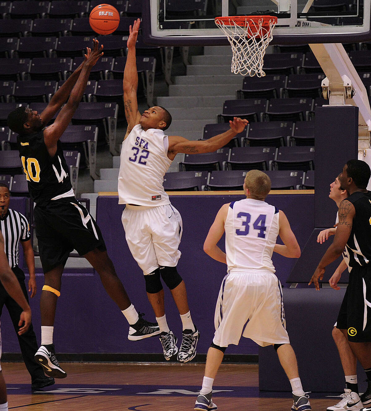 Stephen F. Austin senior forward Taylor Smith, a Clemens grad, tries to block a shot by Grambling center Peter Robinson in a 60-38 SFA victory on Dec. 20, 2012. Smith, who leads the nation in field-goal percentage, is among the top 10 in blocks per game.