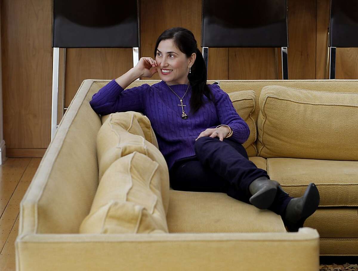 Zem Joaquin sits on one of her flame retardant free sofas in the living room of her home. Zem Joaquin, 42, is a mother of two who has designed her own furniture with no flame retardants. Consumers are interested in organic furniture and beds without polyurethane products.