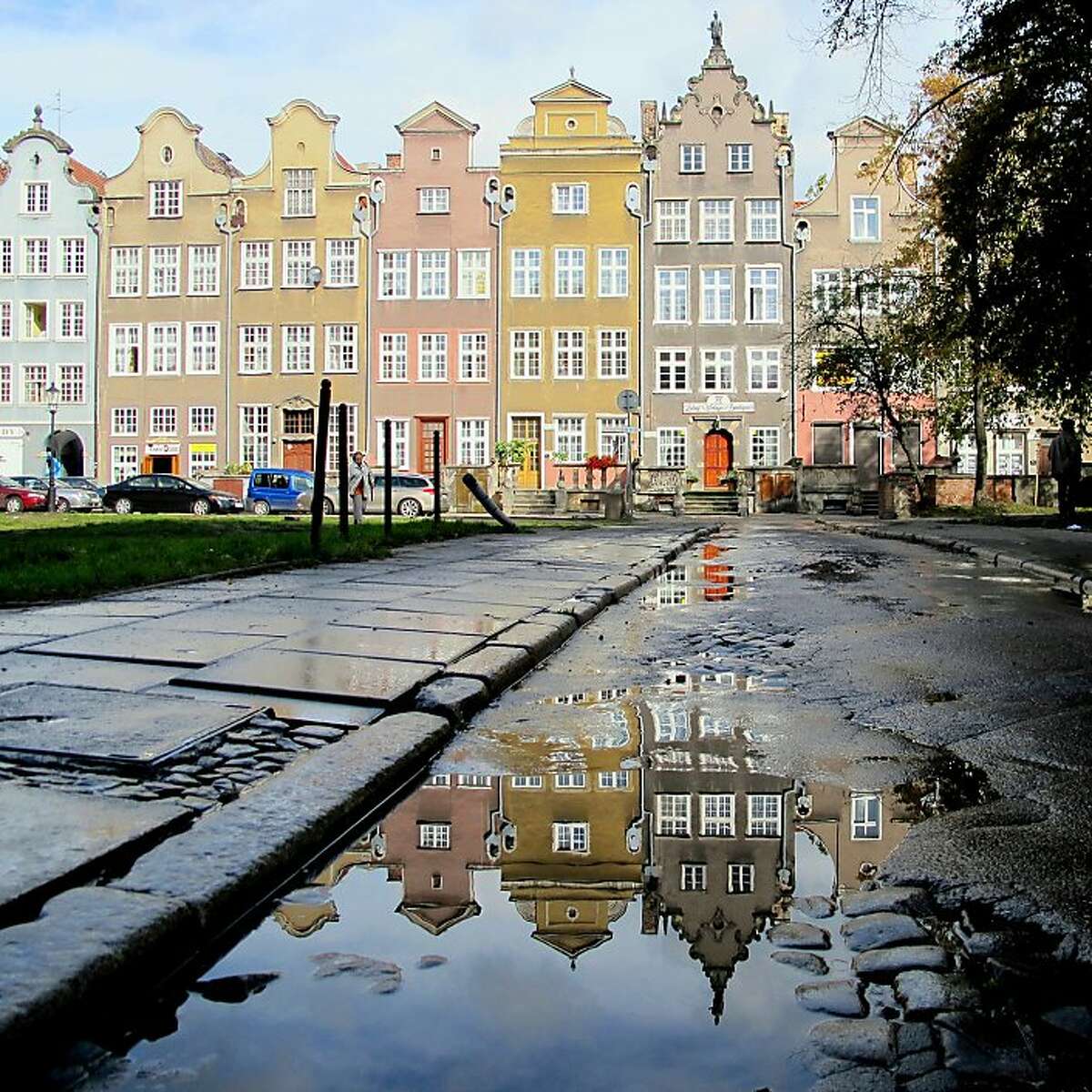 In the old town centre of Gdansk, Poland, a typical row of pastel-coloured old houses, one sunny morning, after a rainy night.