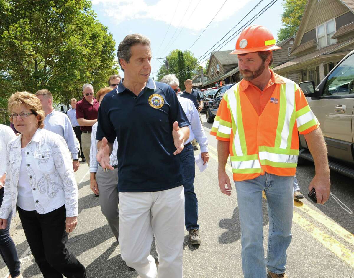 Gov. Andrew Cuomo, left, talks with Department of Transportation engineer Michael Fayette, right, Tuesday, Aug. 30, 2011, in Keene, N.Y. (Cindy Schultz / Times Union)