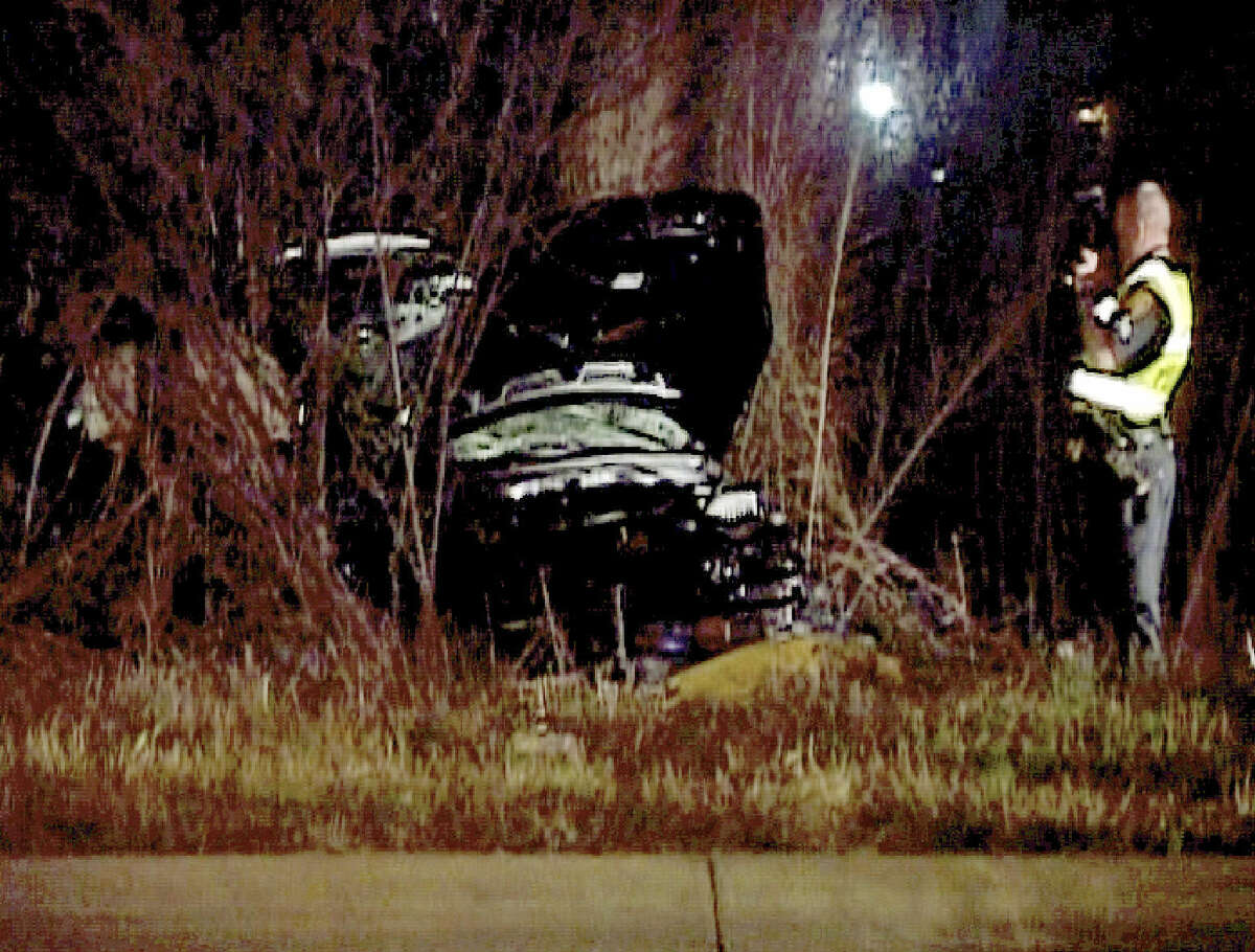 A police officer investigates the site of a wreck in the 11500 block of Crosswinds Way that killed Andrea Reyna. Late for her curfew, the girl was not wearing a seatbelt as she rushed toward home and lost control of her new car, a 2008 Hyundai Accent.