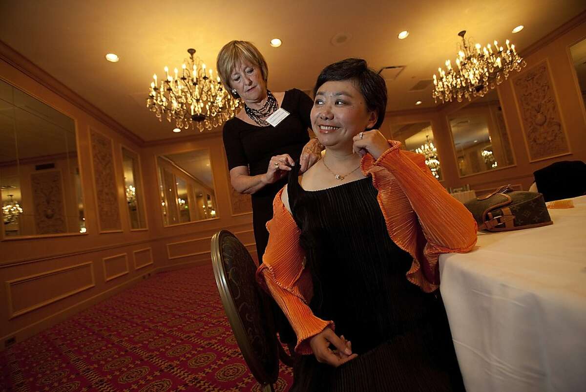 Zheng Cao, (R) a star with the San Francisco Opera has her dress mended by Frederica Von Stade (L) before singing at the opening night of the International Lung Cancer Conference gala at the Fairmont Hotel July 29, 2009 in San Francisco, Calif. (Photograph by David Paul Morris Special to the Chronicle)