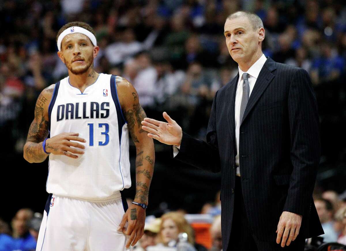 FILE - In this Oct. 17, 2012, file photo, Dallas Mavericks guard Delonte West (13) talks to head coach Rick Carlisle during a break in play against the Phoenix Suns in the first half of a preseason NBA basketball game in Dallas. The Mavericks suspended West Thursday, Oct. 25, for unspecified conduct detrimental to the team, his second such ban in the past 10 days. (AP Photo/Tony Gutierrez, File)