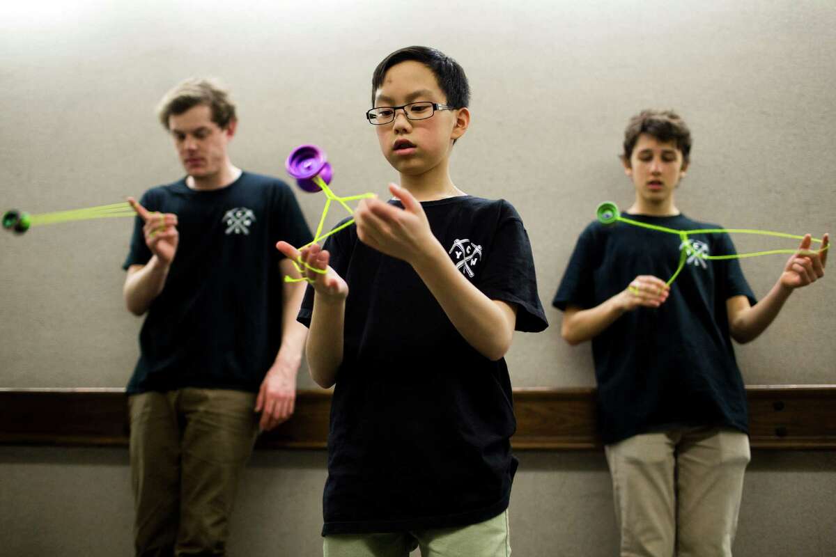 Yo-yo all stars Harrison Lee, 13, the 2012 international rookie of the year, center, Charles Haycock, 19, the 2011 Canadian champion, right, and Jensen Kimmitt, 24, the 2010 world champion, left, warm up in a quiet hallway before their performances at the ninth annual Pacific Northwest Regional Yo-Yo Contest on Saturday, Feb. 23, 2013, at the Seattle Center Armory.