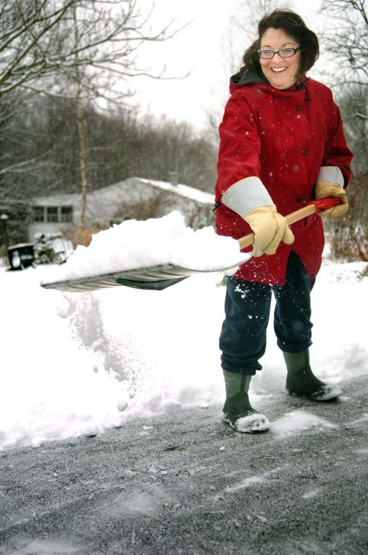 Nancy Arruzza shovels her Ansonia driveway Thursday morning.