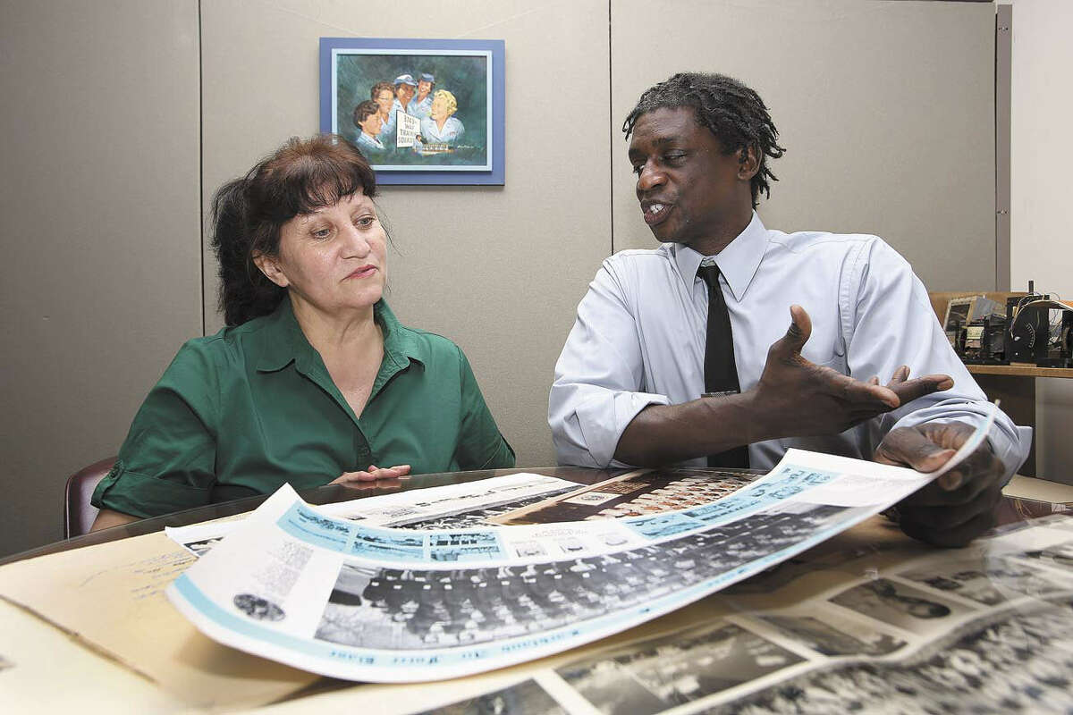 Minnie Martinez, left, administrative assistant for the 37th Training Wing Office of History and Research, is briefed by Tracy English, chief of the department. Martinez and English are compiling images of trainees.