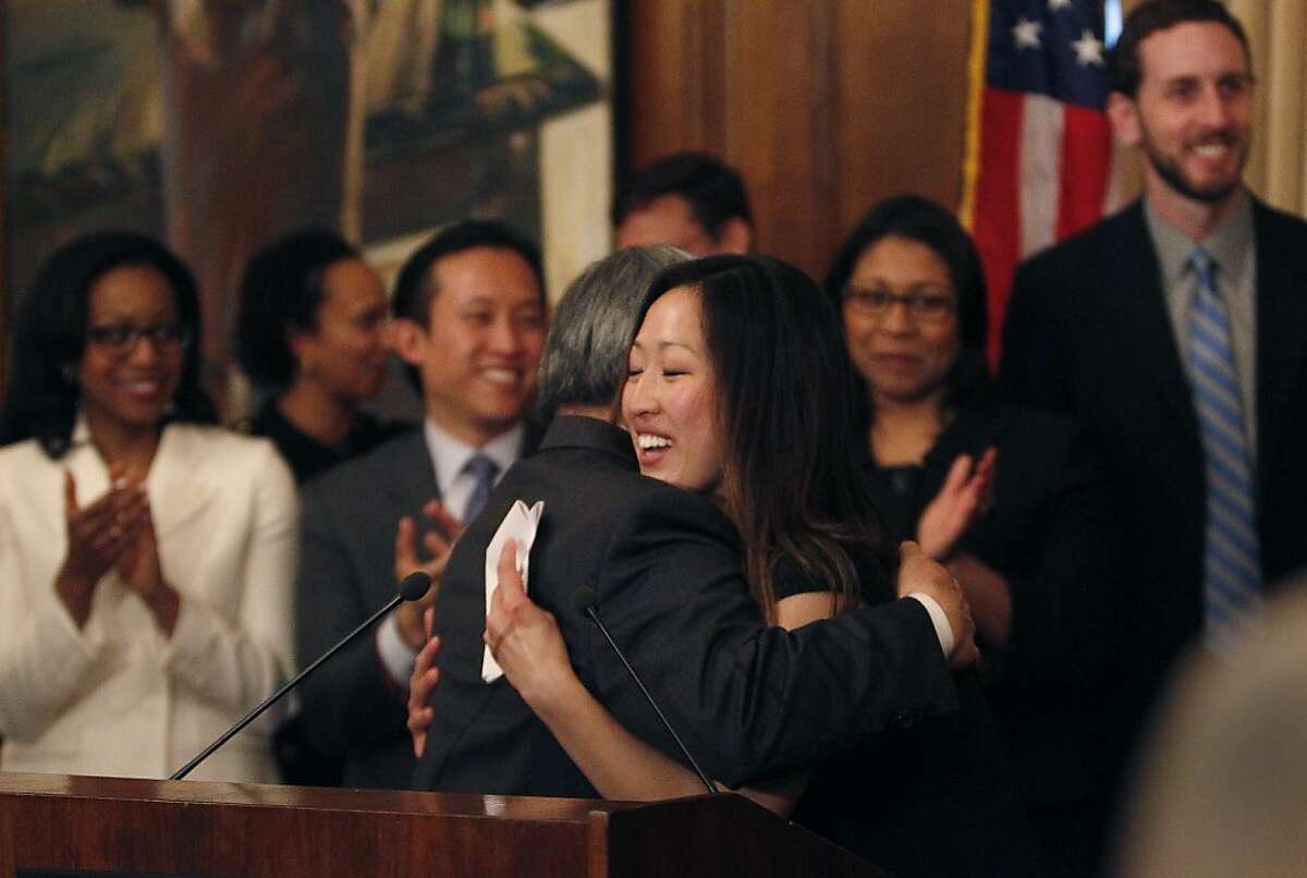 Katy Tang (right), legislative aide to outgoing Supervisor Carmen Chu, and Mayor Ed Lee (left) hug after Mayor Lee announced Tang as his pick to replace Chu as the District Four representative on the Board of Supervisors on Tuesday, February 26, 2013 in San Francisco, Calif.