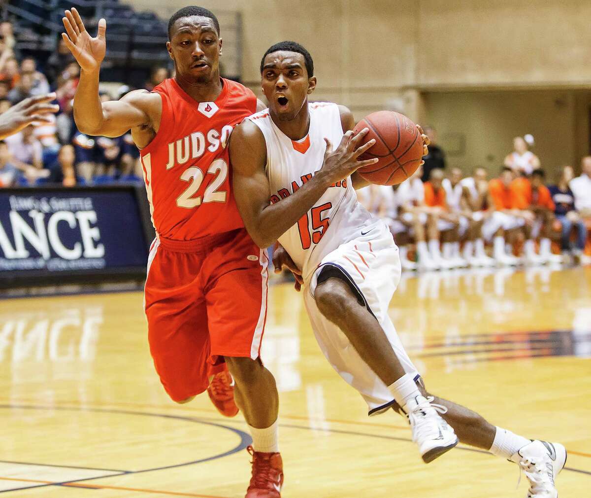 Brandeis' Justin Graham (right) tries to drive past Judson's Jarveon Williams during the second quarter at the Convocation Center. The Broncos won 60-53.