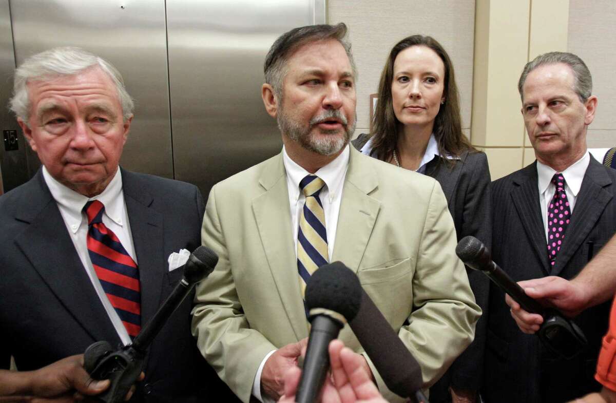 Criminal defense attorney Dick Deguerin, left, with client Michael Brown, and criminal defense attorneys Catherine Baen, and Brian Wice, right, as they talk to the media as they leave the courtroom after Brown was found not guilty of assault in trial at the Harris County Criminal Justice Center, 1201 Franklin, Tuesday, Sept. 20, 2011, in Houston. Brown, a former hand surgeon, was accused of assaulting his fourth wife, Rachel Brown, last year in their Memorial-area mansion. ( Melissa Phillip / Houston Chronicle )