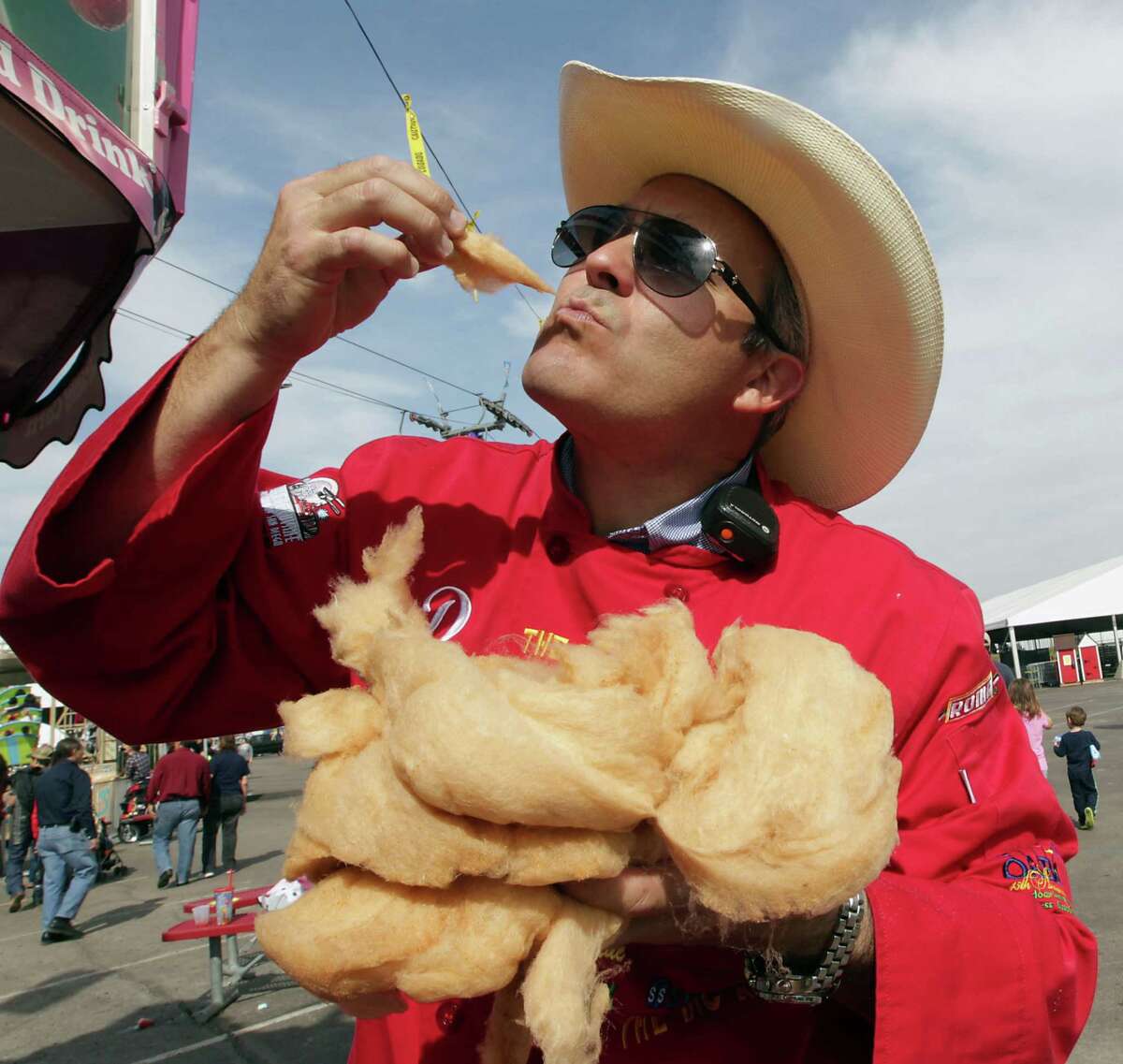 RSC's Dominic "The Midway Gourmet" Palmieri takes a bite of the Bacon Cotton Candy at the Houston Livestock Show and Rodeo Carnival Saturday, Feb. 23, 2013, in Houston. ( James Nielsen / Houston Chronicle )