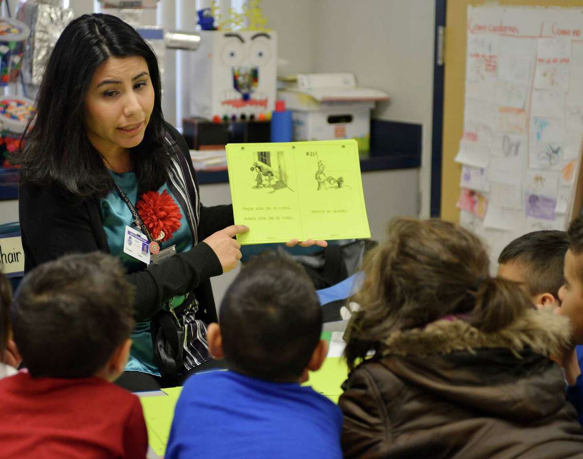 Teacher Debra Gonzalez conducts reading lessons with students in a pre-K Head Start bilingual class, on Feb. 27, 2013, at Somerset Early Childhood Elementary in Somerset.