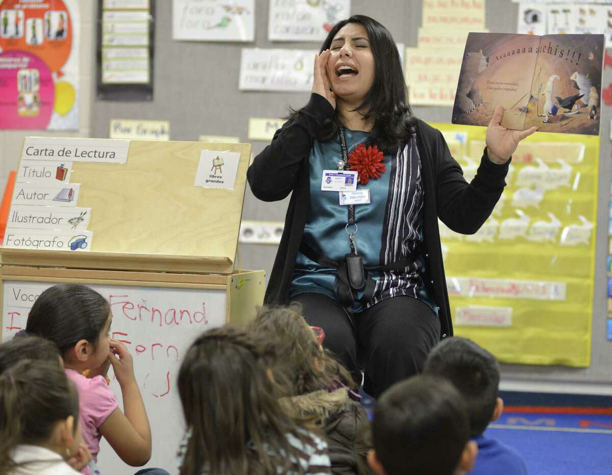 Teacher Debra Gonzalez conducts reading lessons with students in a pre-K Head Start bilingual class at Somerset Early Childhood Elementary in Somerset.