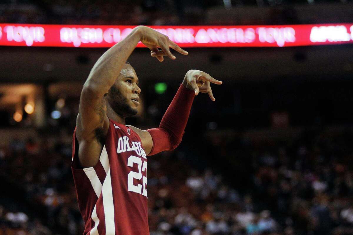 Oklahoma's Amath M'Baye signals "horns down" to the Texas crowd after a dunk in the second half of an NCAA basketball game in Austin, Texas on Feb. 27, 2013. (AP Photo/The Daily Texan, Lawrence Peart)