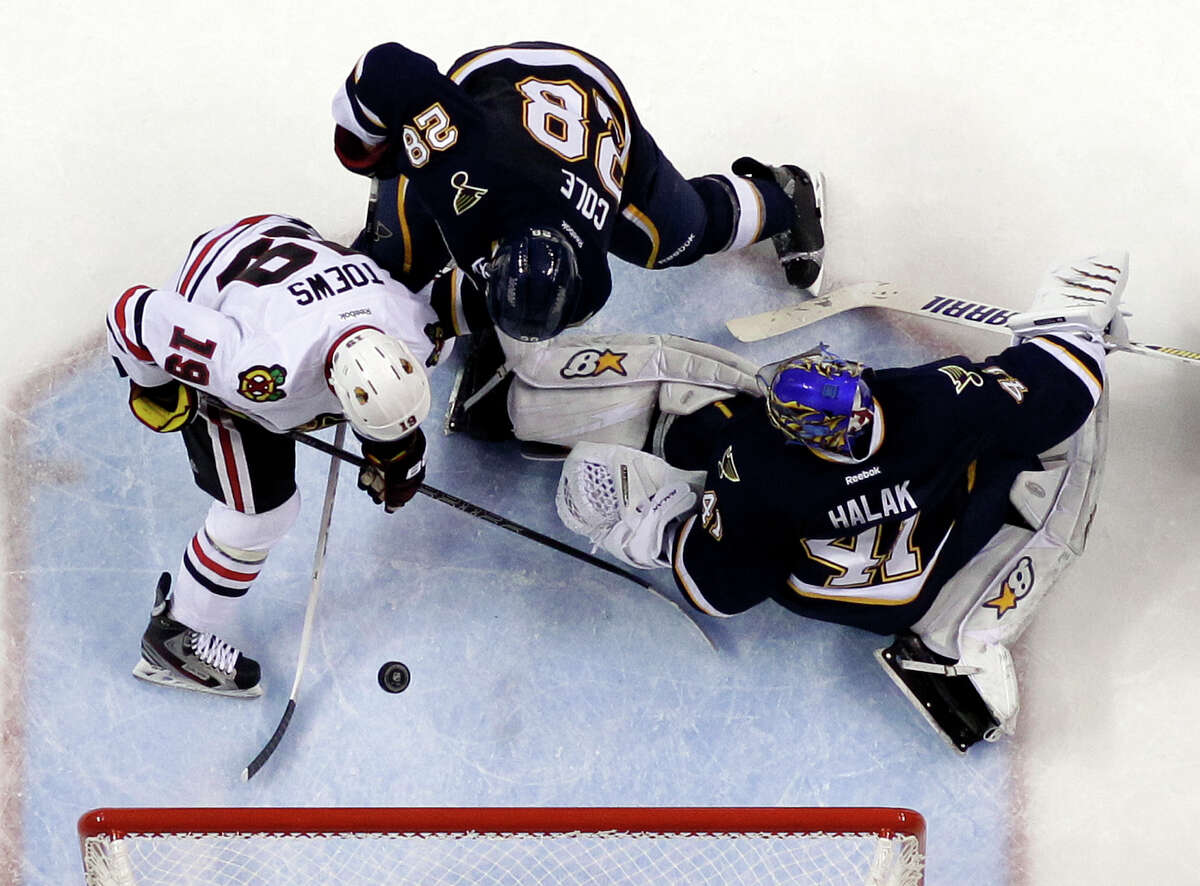 The Blackhawks' Jonathan Toews, left, scores his second goal of the game past Blues goalie Jaroslav Halak, who lost for the first time in regulation this season.