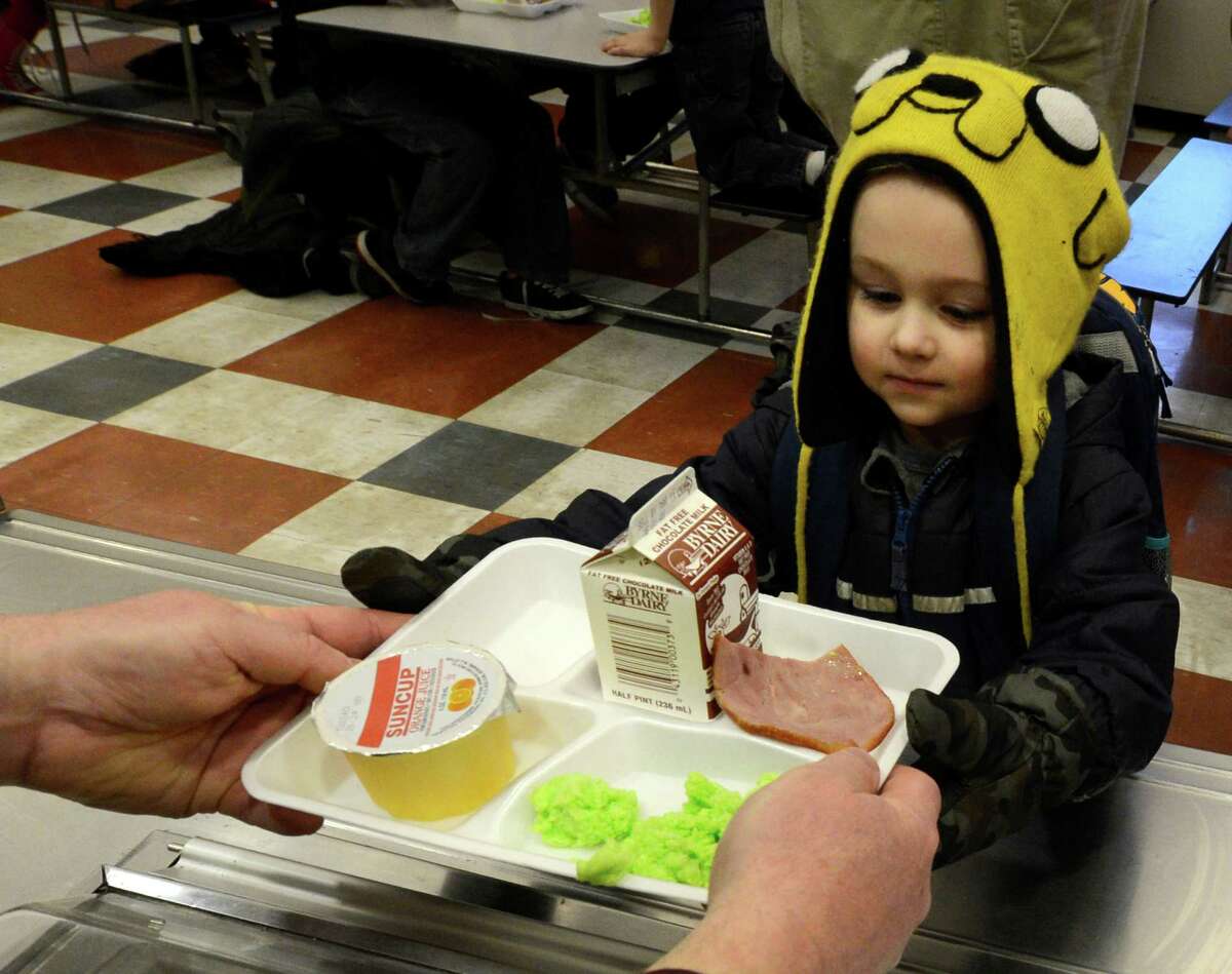 Joseph Tulchinskiy gets some green eggs and ham on Friday, March 1, 2013 in the cafeteria at Troy, N.Y. P.S. 16 on the occasion of Dr. Seuss' 99th birthday. (Skip Dickstein/Times Union)
