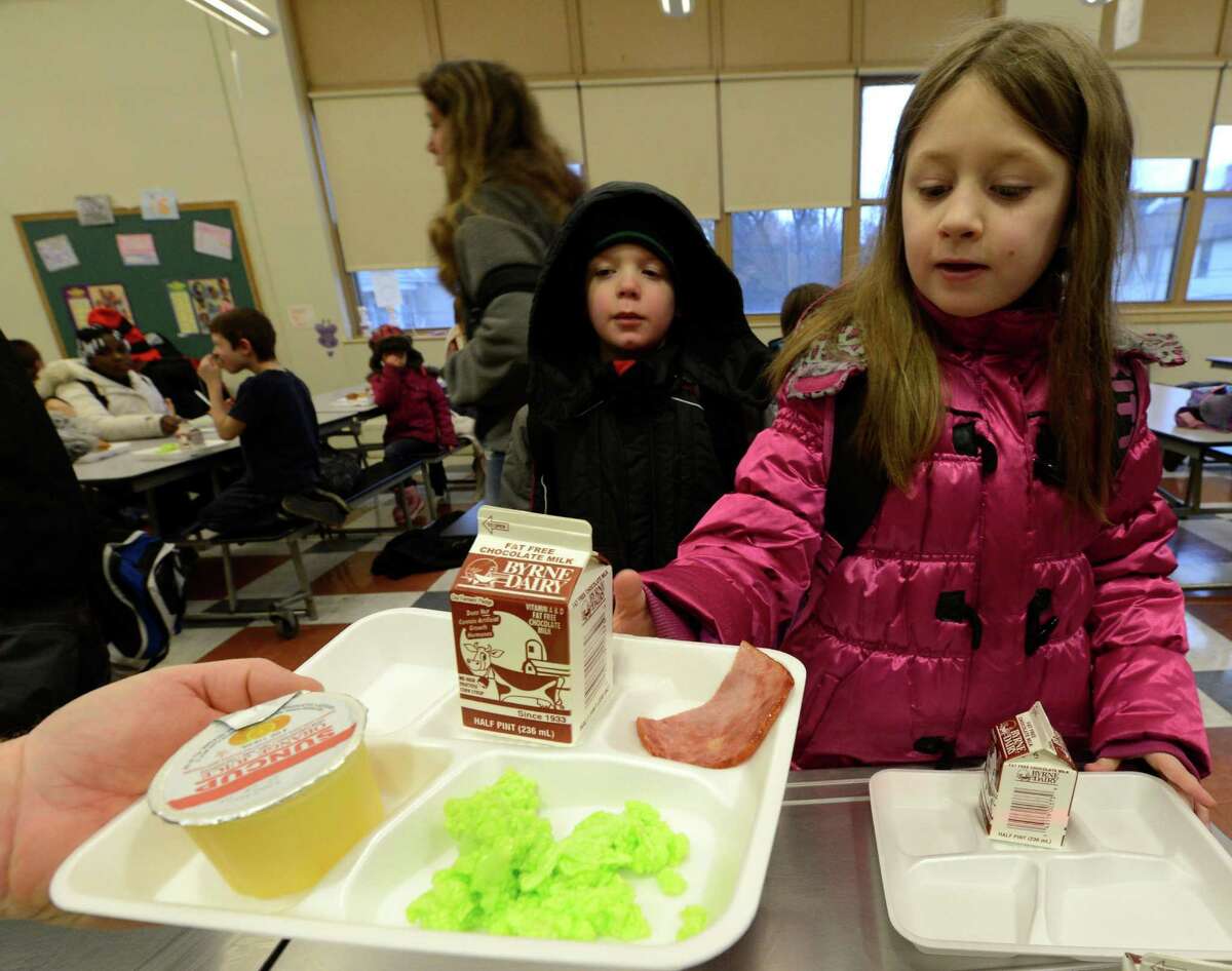 Makayla O'Brien-Cooper gets some green eggs and ham on Friday, March 1, 2013 in the cafeteria at Troy, N.Y. P.S. 16 on the occasion of Dr. Seuss' 99th birthday. (Skip Dickstein/Times Union)