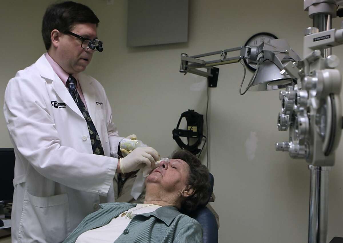 Ophthalmologist Dr. Andrew Calman prepares Elaine Strazzino for an injection at the Premier Eyecare clinic in San Francisco, Calif. on Friday, March 1, 2013.