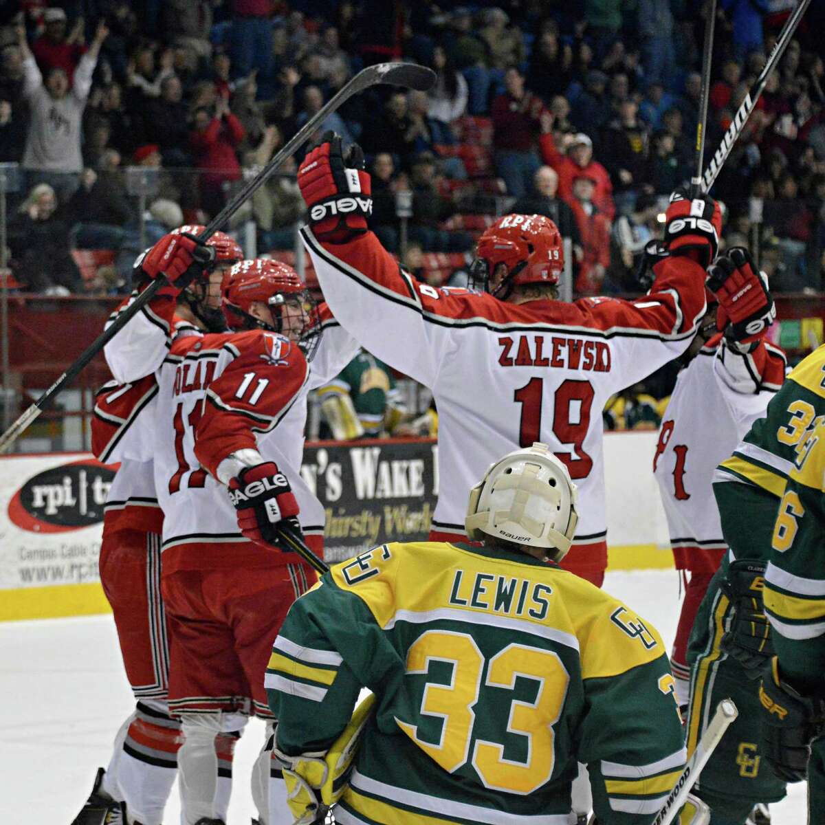 RPI players celebrate a goal ny Milos Bubela in front of Clarkson's goalie Greg Lewis during Friday's game at the Houston Field House in Troy Friday March 1, 2013. (John Carl D'Annibale / Times Union)