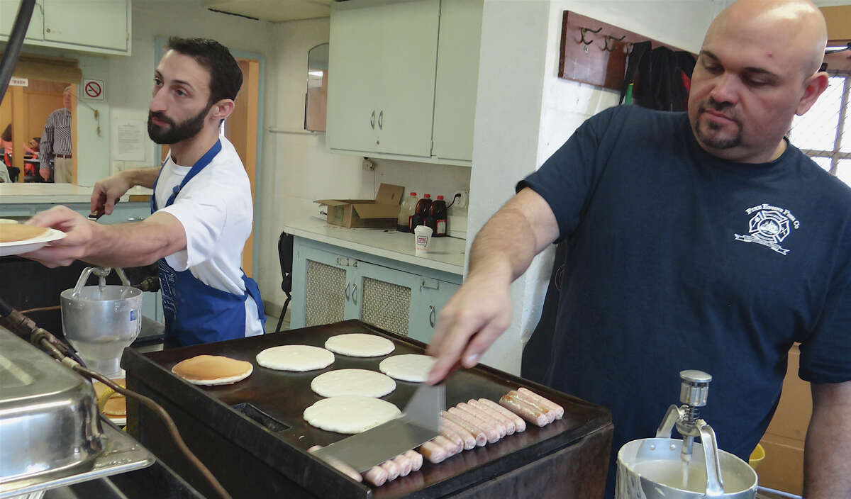 Greg Schroder, left, and Phil Segneri at the grill turning out pancakes for the Fairfield Masonic Lodge's annual pancake breakfast fundraiser Saturday. FAIRFIELD CITIZEN, CT 3/2/13