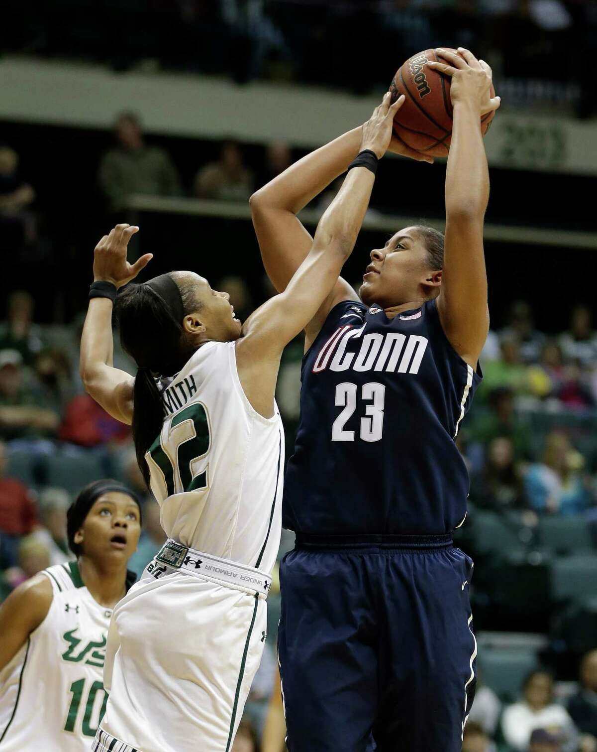 Connecticut forward Kaleena Mosqueda-Lewis (23) shoots over South Florida guard Andrell Smith (12) during the second half of an NCAA women's college basketball game Saturday, March 2, 2013, in Tampa, Fla. Connecticut won the game 85-51. (AP Photo/Chris O'Meara)