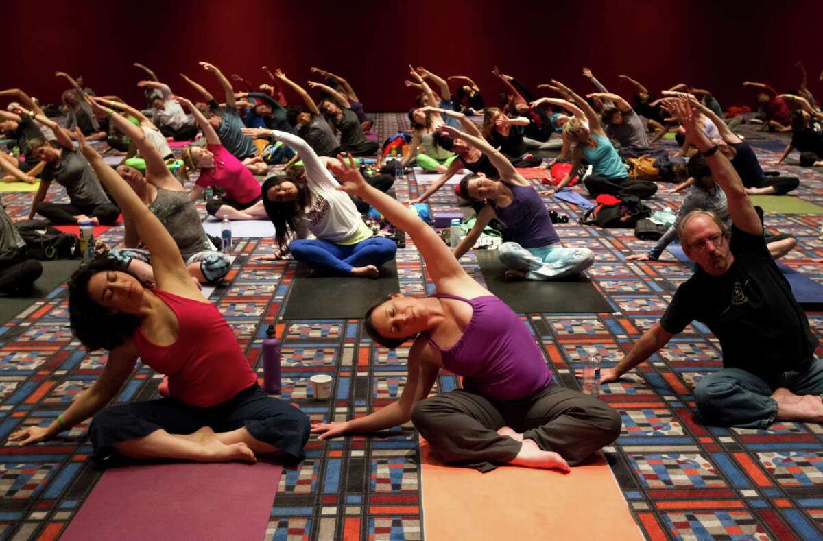 Participants perform yoga techniques during the 2013 Yoga Conference.