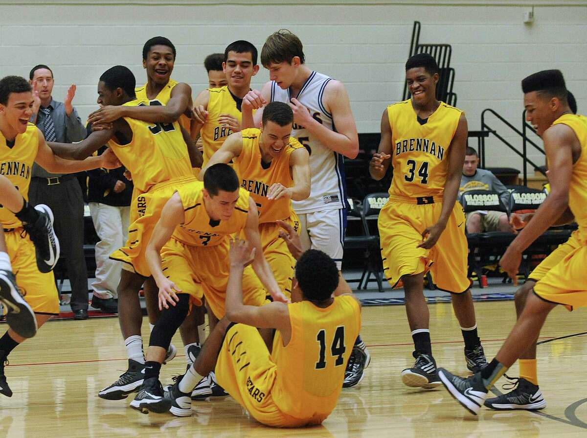 The Brennan Bears celebrate their overtime victory over the Alamo Heights Mules in the Region iV-4A final at Littleton Gym on Saturday, March 2, 2013.