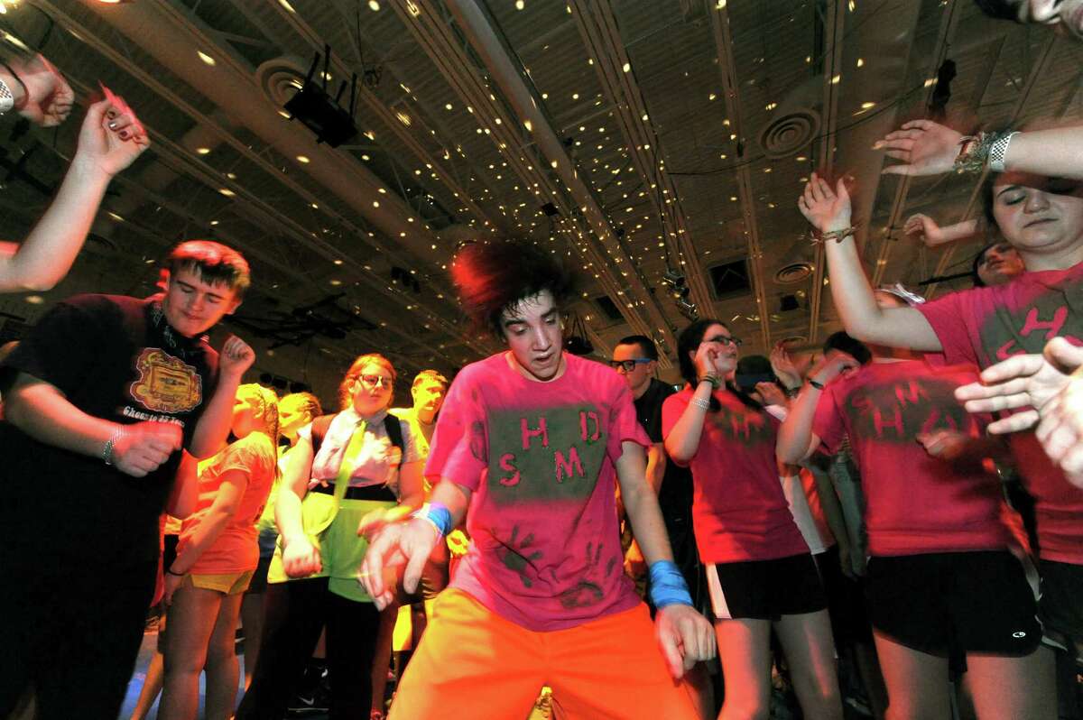South Glens Falls junior James Greene, center, joins other students dancing during the 36th annual South Glens Falls H.S. Dance Marathon on Saturday March 2, 2013 in South Glens Falls, N.Y. 800 students busted a move to raise money for people from the community who are in need, mostly because of illness. (Michael P. Farrell/Times Union)