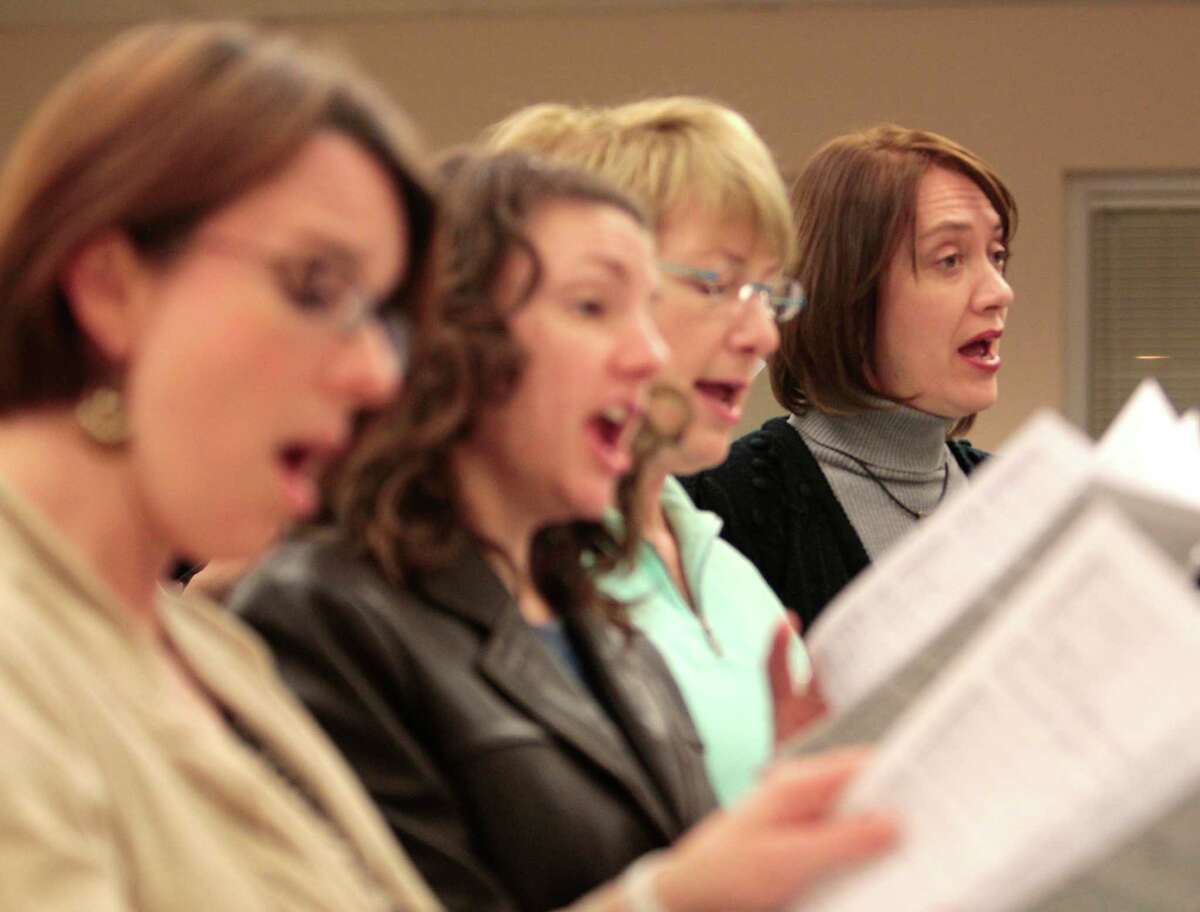 Ann Harlan, right, sings as a few of St. Anne's choir members rehearse at the church last week.