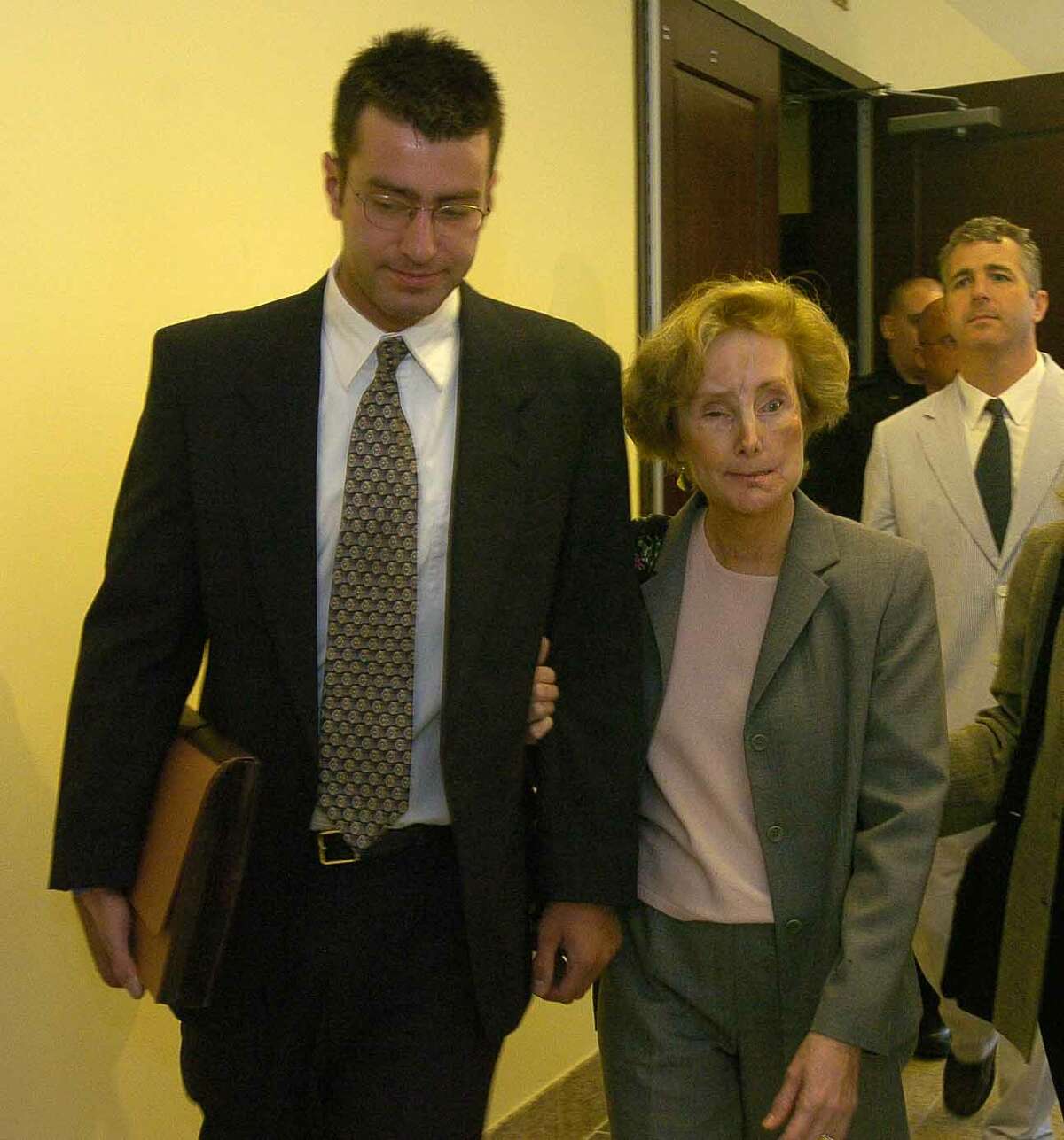 Times Union staff photo by Paul Buckowski --- Christopher Porco, left, and his mother, Joan Porco, right, leave Albany County court in Albany, N.Y. on Tuesday, May 16, 2006 during a break in pretrial hearings. Christopher is charged in the death of his father, Peter Porco and the attack of his mother back November of 2004.