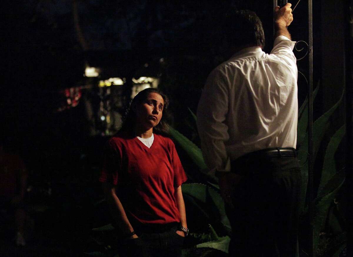 Anna Vasquez, who was paroled in November, talks with her brother Jerry Vasquez on their mother's porch.