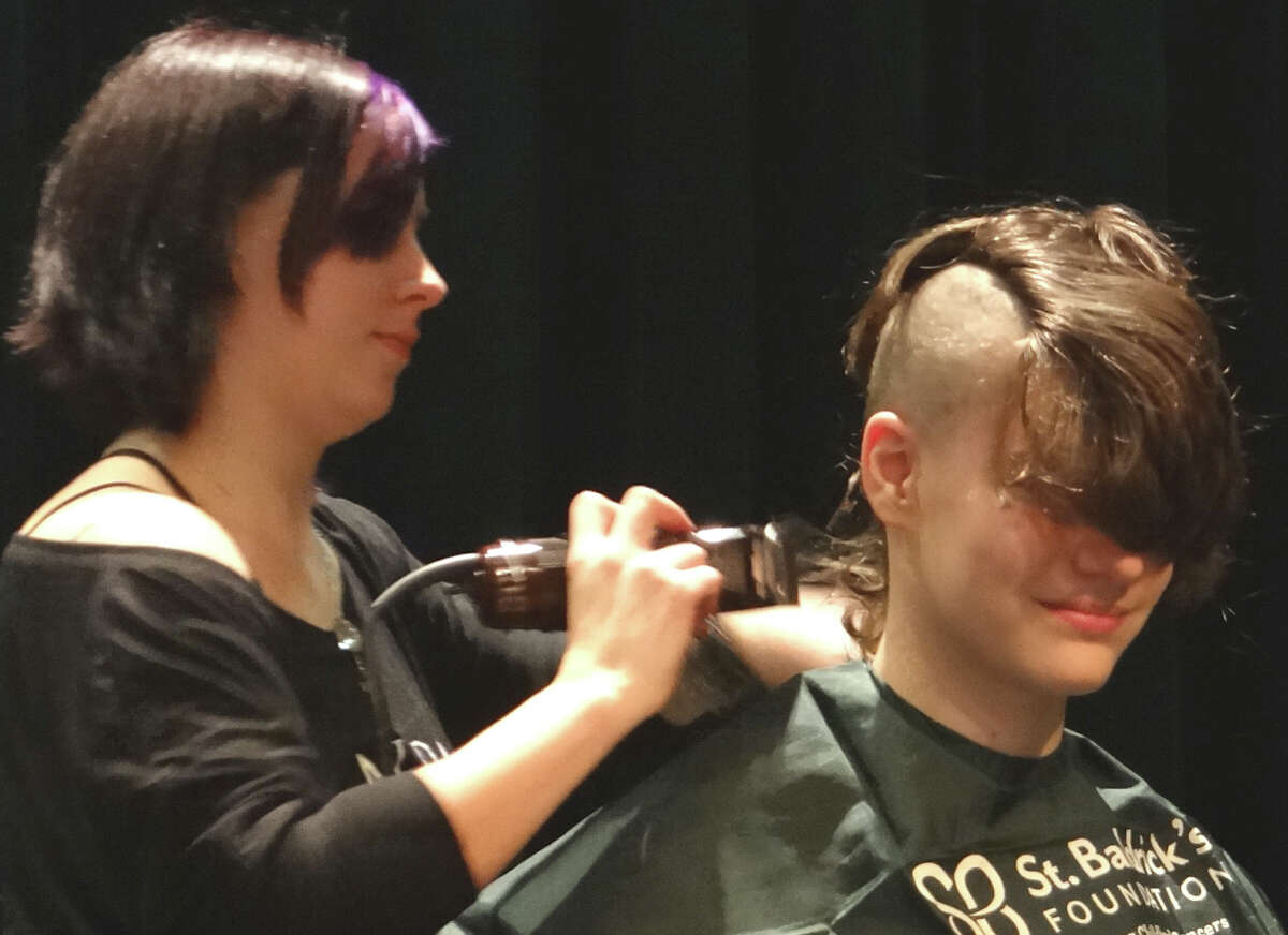 Sam Mahler, 15, of Fairfield, the first young person inducted Sunday as a Knight of the Bald Table, gets his head shaved at Team Brent's St. Baldrick's Day event. FAIRFIELD CITIZEN, CT 3/3/13