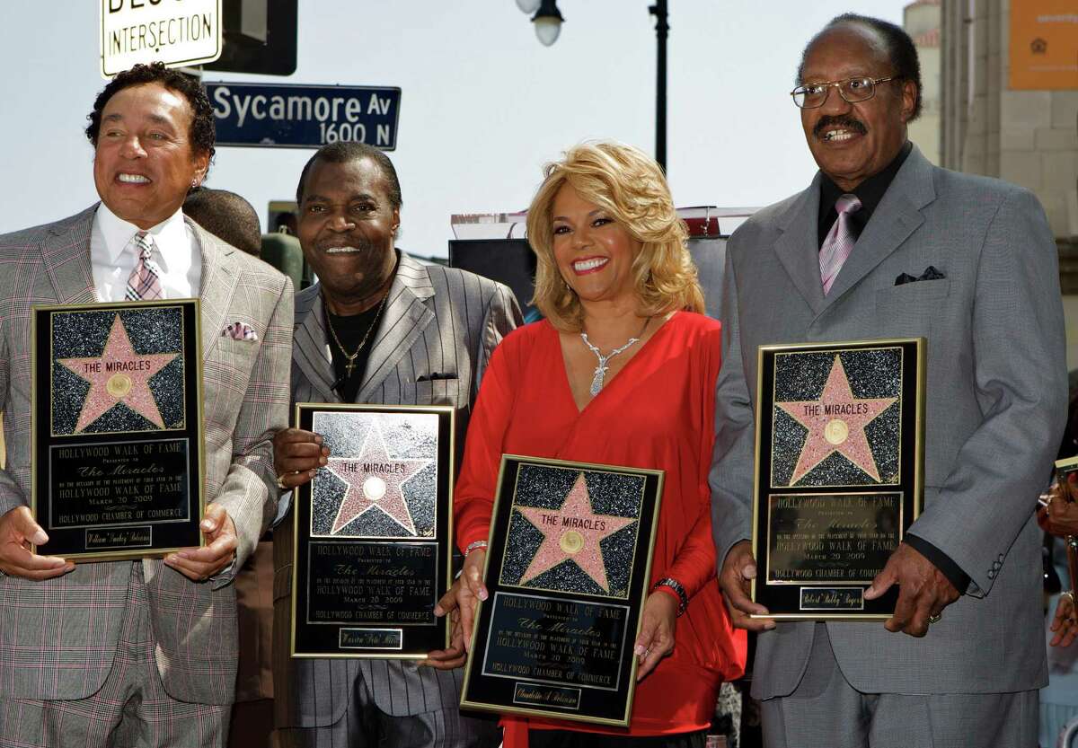 FILE - In this March 20, 2009 file photo, members of the Motown group The Miracles, from left: William "Smokey" Robinson, Warren "Pete" Moore, Claudette Robinson, and Robert "Bobby" Rogers, are honored with a star on the Hollywood Walk of Fame in Los Angeles. Rogers, a founding member of the group and a collaborator with Smokey, has died. Motown Museum board member Allen Rawls said Rogers died Sunday, March 3, 2013, at his home. He was 73. (AP Photo/Damian Dovarganes, file)