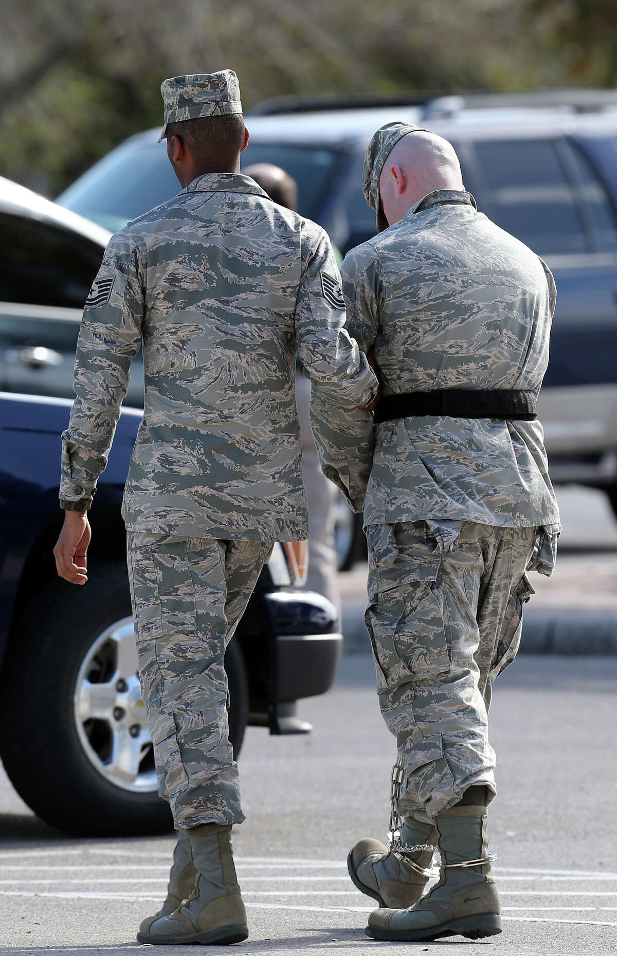 Staff Sgt. Ryan Deraas of the 326th Training Squadron is led away after his conviction at Lackland Air Force Base, Monday, March 4, 2013. Deraas pled guilty to various charges including unprofessional relationships with five technical training students. He was handed a three-month sentence, dishonorably discharged and a reduction in rank.