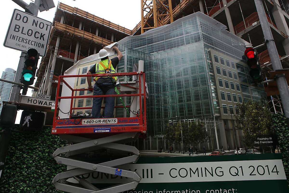 A construction worker puts a face on the Foundry Square III building under construction on Howard at First streets in San Francisco, Calif., on Monday, March 4, 2013. San Francisco is leading the nation in office rental rate growth.