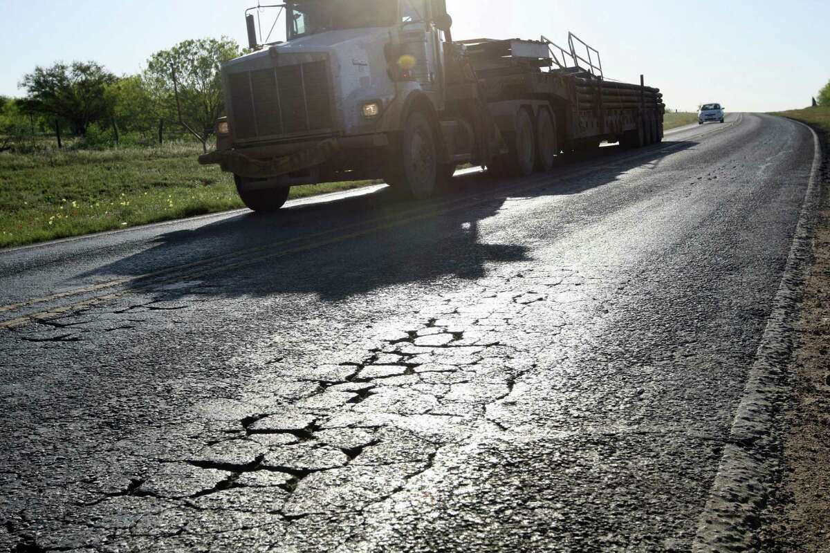 A truck in the oil and gas industry drives near Cotulla. One Texas representative has filed a bill to use $1.4 billion from the rainy day fund to repair roads in counties affected by such traffic.
