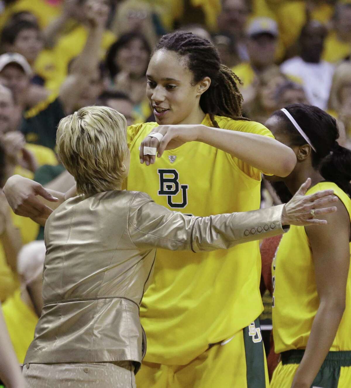 Baylor's Brittney Griner hugs coach Kim Mulkey. “Got a dunk finally at home, scored 50. I mean there's not a better way to go out,” the center said.